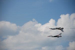 Two jets flying in formation one upside down over the other